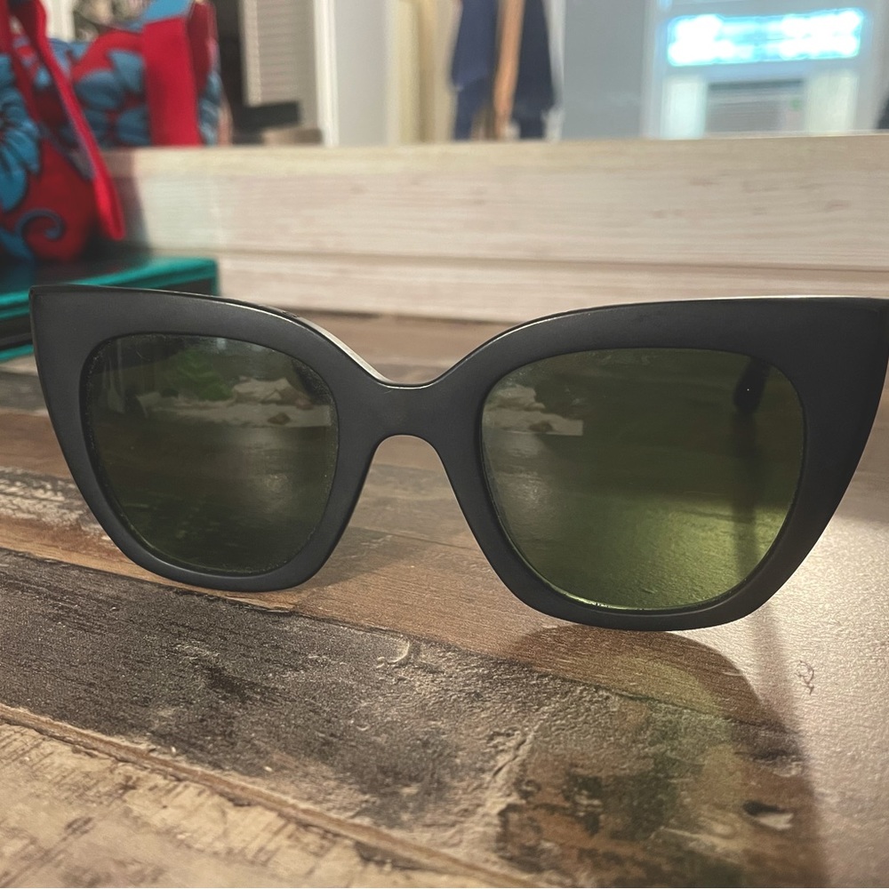 Tom’s solid black sunglasses
